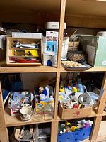 overall view of shelves with cleaning bottles, paint brushes, jars and containers
