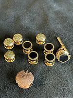 Group shot of all items: cufflink, eight studs, Masonic pin
