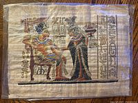 Full view of painted papyrus under plastic showing entire scene and hieroglyphs