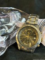 Front view of Seiko two-tone chronograph watch on display stand