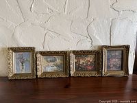 Front view of all four framed prints aligned on surface