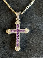 Front view of sterling silver cross pendant with chain
