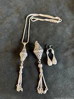 Full set showing necklace with small pendant, separate large pendant, and earrings