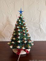 Full view of ceramic Christmas tree on base with cord