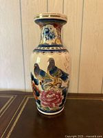 Full view of porcelain vase front showing bird and floral design