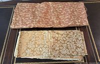 Two folded fabric lengths on table