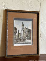 Full view of framed etching on wall