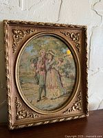 Full view of framed needlepoint artwork