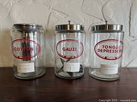 Front view of three labeled glass jars