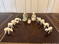 Full set arranged in arc: Joseph, Mary, baby Jesus, ten sheep