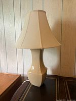 Front view of ceramic lamp with shade showing overall form and color