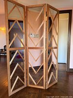 Full view of 3-panel mirrored wood floor screen, panels partially folded