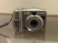 Front view showing Panasonic Lumix DMC-LC50, Leica lens, flash, 3.2MP marking