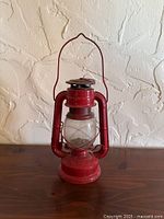 Full view of red kerosene lantern front