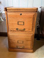 Front view showing full cabinet, both drawers, lock, hardware