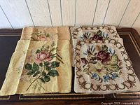 Four needlepoint cushion covers: two beige with pink rose, two ivory with burgundy rose and scroll border