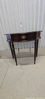 Front view of demilune console table