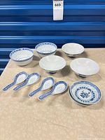 Front view showing four bowls, two dishes, four spoons