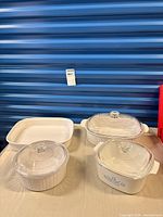 Group shot of four CorningWare dishes with lids