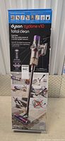 Retail box front showing Dyson Cyclone V10 Total Clean vacuum and accessory images