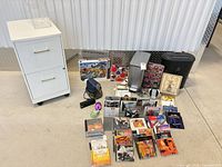 Overall view of filing cabinet, shredder, phone, CDs, puzzles and office accessories