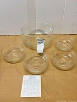 Full set: one large and four small clear crystal bowls with care pamphlet