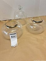 Overview of two crystal bowls with lattice lids and one crystal cloche