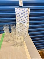 Six etched crystal glasses beside two Princess House boxes