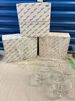 Lot overview showing boxes, two flutes, four dessert dishes