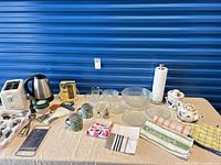 Full table view showing all porcelain pieces, appliances, glassware, utensils and linens