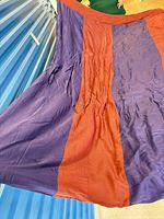 Full view of purple and rust red silk duvet spread out