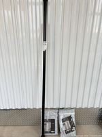 Full view of curtain rod and two packaged curtain panels