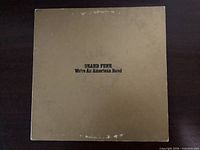 Front of gold album cover displaying title and artist