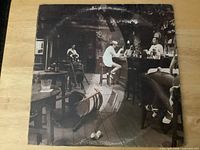 Front of gatefold jacket showing bar scene