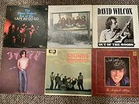 Overall shot of six LP record jackets laid out, front cover artwork visible