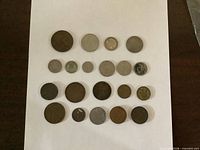 Twenty coins arranged in five rows on white background
