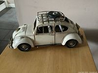 Left side view of metal Volkswagen Beetle model on table