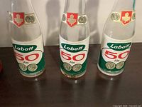 Front view of three Labatt 50 Ale bottles showing labels
