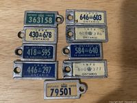 All nine War Amps key tags laid out, showing years and licence numbers