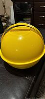 closed yellow spherical picnic carrier