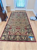 Full view of rug on floor showing overall design and dimensions