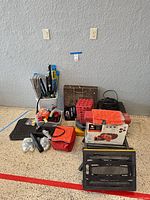 Overall view of mixed automotive and RV accessories grouped on garage floor