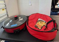 Electric skillet, glass lid, bag with booklet visible