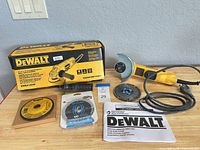 Full lot showing grinder, box, handle, guard, discs, manual