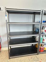 Front view of shelving unit showing four shelves and frame