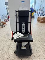 Creeper in seat position showing padding, frame, casters and manual