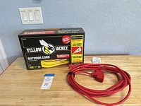 Boxed Yellow Jacket cord beside coiled red cord