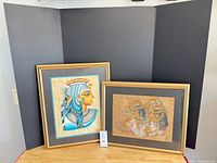 Both framed papyrus artworks side by side