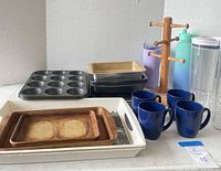 overview of all items including stoneware bakers, bakeware, mugs, bottles, tray, mug tree