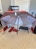Umbrella fully opened with accessories laid out